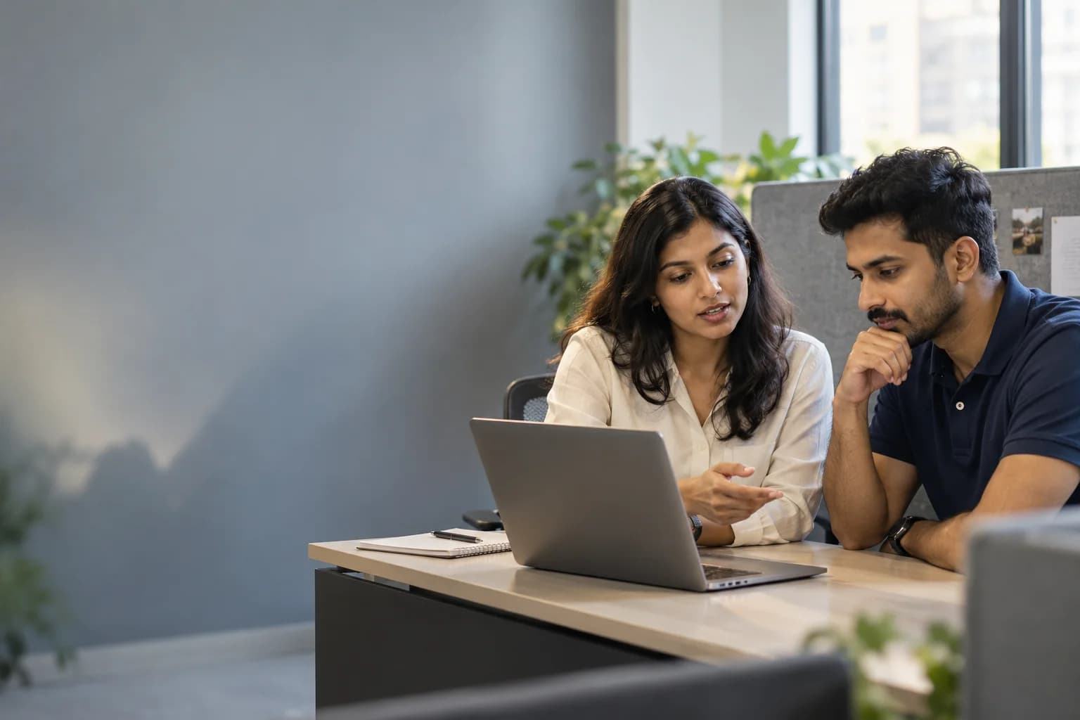 Two teammates reviewing a conversation before a personal reply